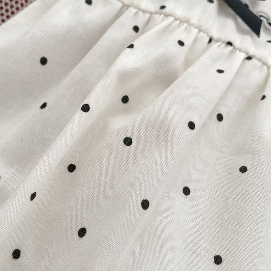 Monos triangulares con cuello de muñeca y estampado de lunares para niña